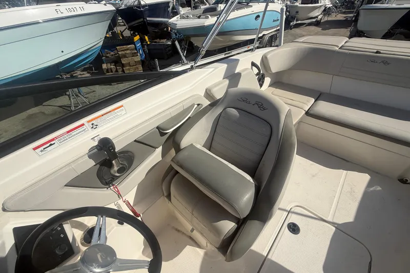Slide: The Image of 2020 Sea Ray SPX 210 Outboard boat interior with steering wheel and seating. - 12
