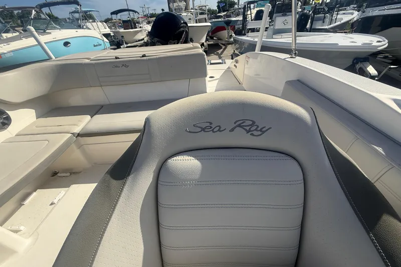 Slide: The Image of 2020 Sea Ray SPX 210 Outboard boat interior with seating and logo. - 16