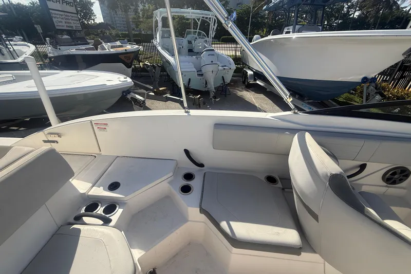 Slide: The Image of 2020 Sea Ray SPX 210 Outboard boat interior with seating and cup holders. - 18