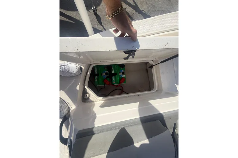 Slide: The Image of 2020 Sea Ray SPX 210 Outboard boat battery compartment with open hatch. - 21