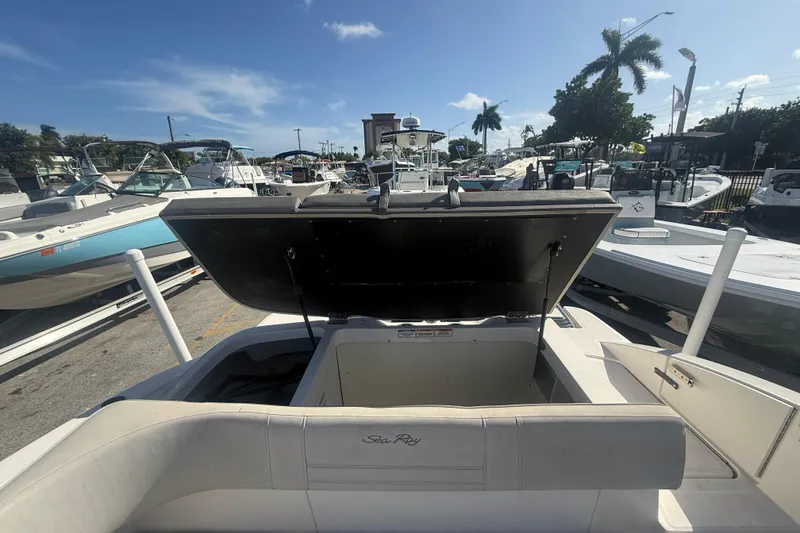 Slide: The Image of 2020 Sea Ray SPX 210 Outboard boat with open storage compartment at marina. - 22
