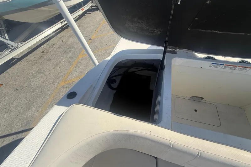 Slide: The Image of Open storage compartment on a 2020 Sea Ray SPX 210 Outboard boat. - 23