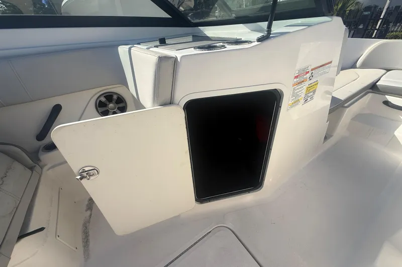 Slide: The Image of Open storage compartment on a 2020 Sea Ray SPX 210 Outboard boat interior. - 24