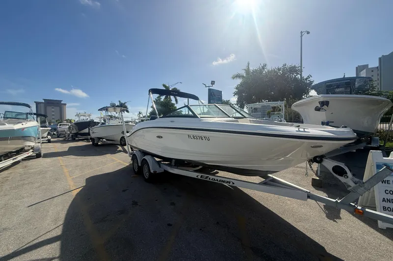 Slide: The Image of 2020 Sea Ray SPX 210 Outboard boat on trailer under sunny sky. - 3