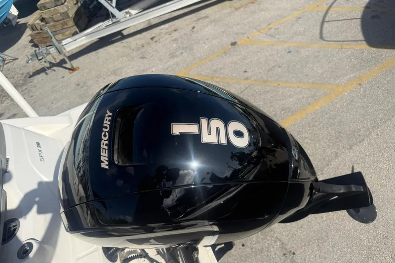 Slide: The Image of 2020 Sea Ray SPX 210 Outboard with Mercury 150 engine in a parking lot. - 4