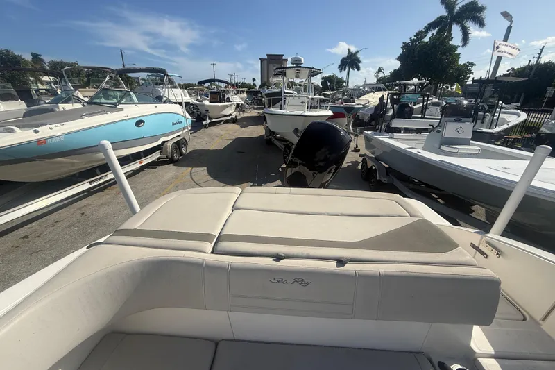 Slide: The Image of 2020 Sea Ray SPX 210 Outboard boat in marina, surrounded by other boats. - 7