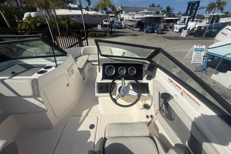 Slide: The Image of 2020 Sea Ray SPX 210 Outboard boat interior with steering wheel and dashboard. - 9