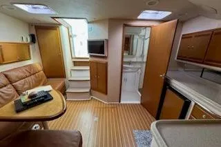 Slide: The Image of Interior of a 2008 Cabo 40 Express yacht with cozy seating and modern amenities. - 11