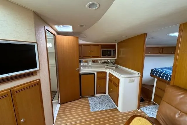 Slide: The Image of Interior of 2008 Cabo 40 Express yacht with kitchenette and cozy sleeping area. - 12