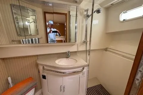 Slide: The Image of 2008 Cabo 40 Express yacht bathroom with sink, mirror, and shower. - 13