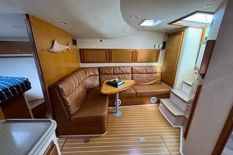 Slide: The Image of 2008 Cabo 40 Express yacht interior with leather seating and wooden flooring. - 14