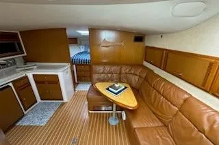 Slide: The Image of 2008 Cabo 40 Express yacht interior with leather seating and kitchenette. - 15