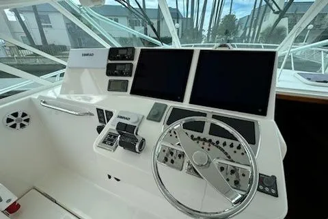 Slide: The Image of 2008 Cabo 40 Express boat helm with dual screens and control panel. - 19