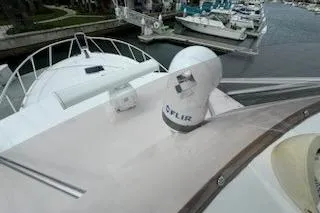 Slide: The Image of 2008 Cabo 40 Express yacht with FLIR camera on deck, docked at marina. - 26