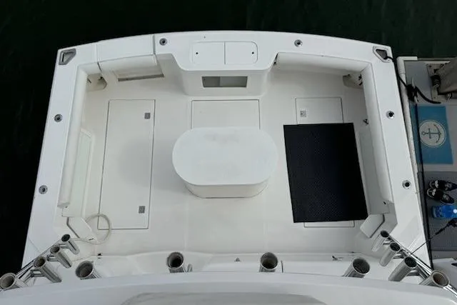 Slide: The Image of 2008 Cabo 40 Express boat deck with white seating and storage compartments. - 27