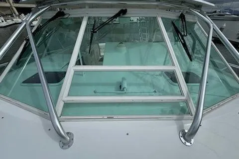 Slide: The Image of 2008 Cabo 40 Express boat windshield with wipers and metal railings. - 31