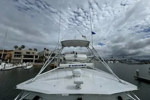 Slide: The Image of 2008 Cabo 40 Express boat docked in a marina under cloudy skies. - 32