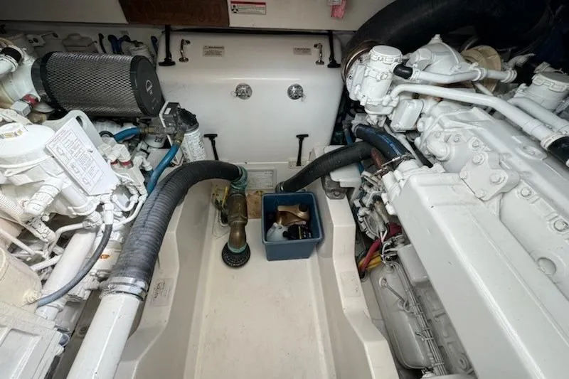 Slide: The Image of Engine room of a 2008 Cabo 40 Express boat, showcasing mechanical components and hoses. - 34