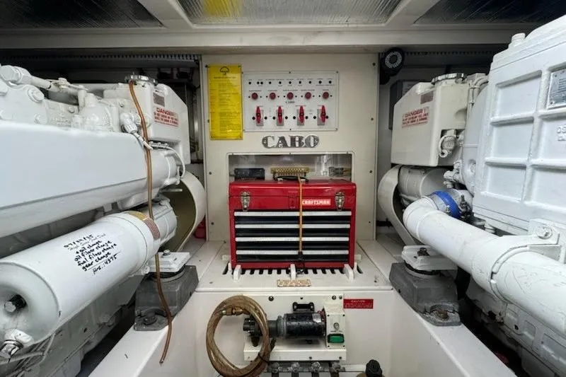 Slide: The Image of Engine room of 2008 Cabo 40 Express with red toolbox and control panel. - 35