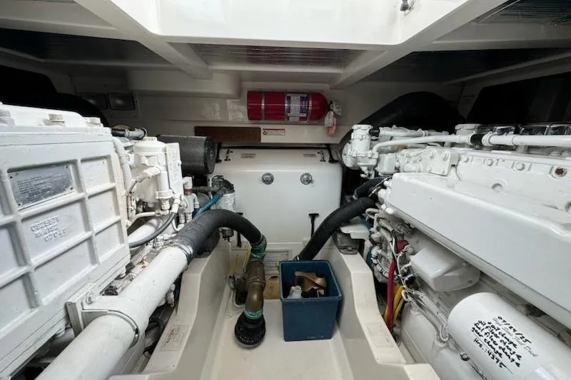 Slide: The Image of Engine room of a 2008 Cabo 40 Express boat, featuring mechanical components and a fire extinguisher. - 36