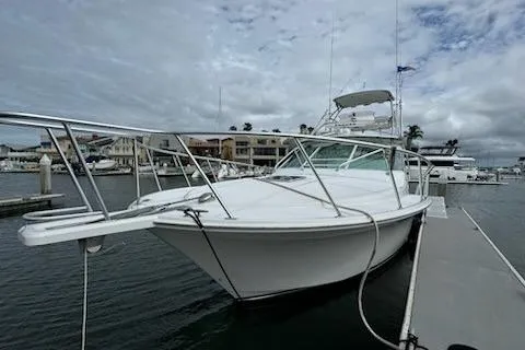 Slide: The Image of 2008 Cabo 40 Express yacht docked at marina under cloudy sky. - 4