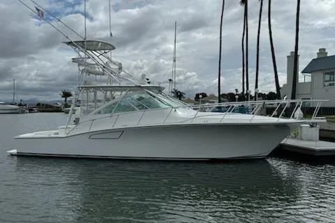 Slide: The Image of 2008 Cabo 40 Express yacht docked in a marina under cloudy skies. - 5