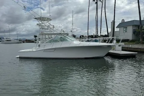 Slide: The Image of 2008 Cabo 40 Express yacht docked in a marina with cloudy skies. - 6