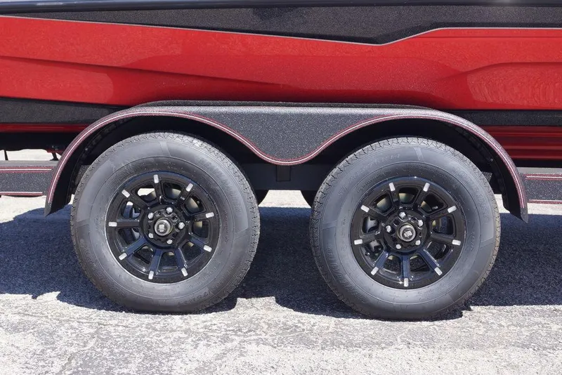 Slide: The Image of Trailer wheels of a 2026 Skeeter ZXE21 boat, featuring black rims and red accents. - 10