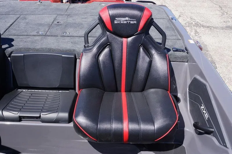 Slide: The Image of 2026 Skeeter ZXE21 boat seat with black and red design, showcasing sleek style and comfort. - 13