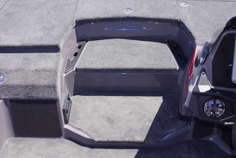 Slide: The Image of Interior view of 2026 Skeeter ZXE21 boat with carpeted steps and dashboard details. - 19