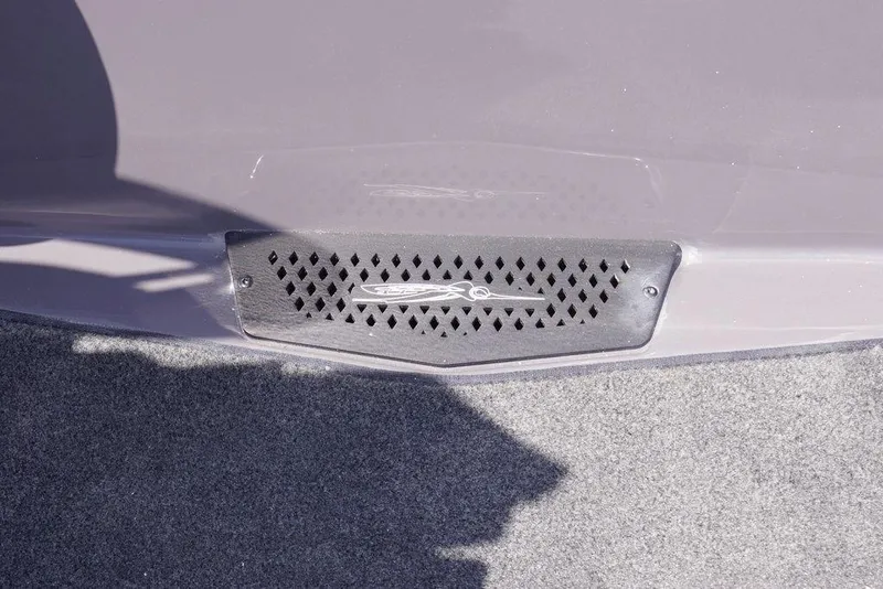 Slide: The Image of 2026 Skeeter ZXE21 boat detail with vented panel and logo on carpeted surface. - 20