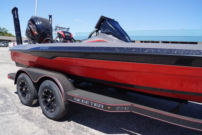 Slide: The Image of 2026 Skeeter ZXE21 boat with red hull on a trailer, featuring a powerful outboard motor. - 3