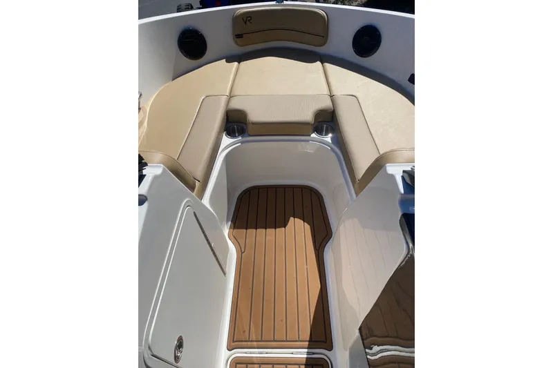 Slide: The Image of 2023 Bayliner VR5 Bowrider I/O interior with tan seating and wood-style flooring. - 4