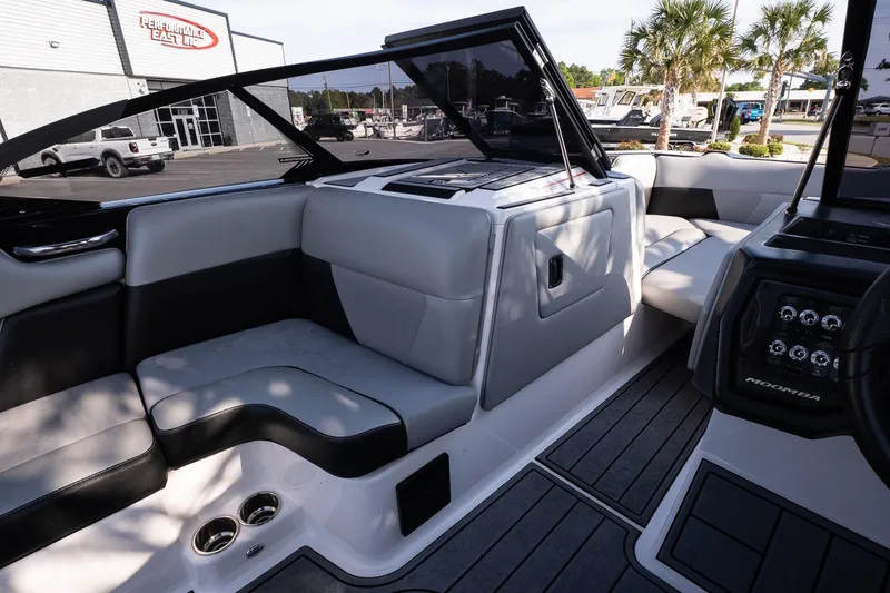 Slide: The Image of 2022 Moomba Max boat interior with gray seating and modern dashboard design. - 12