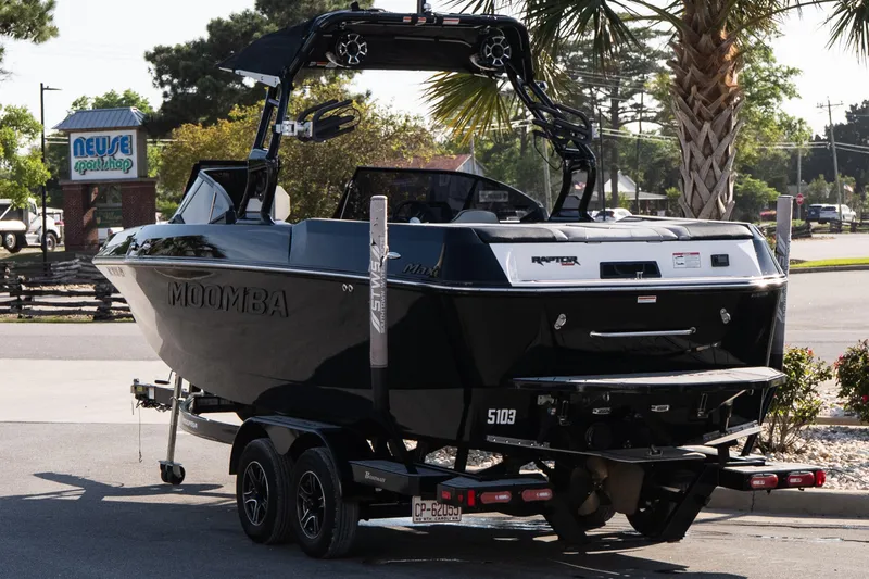 Slide: The Image of 2022 Moomba Max boat on trailer near Neuse Sport Shop, parked outdoors. - 4