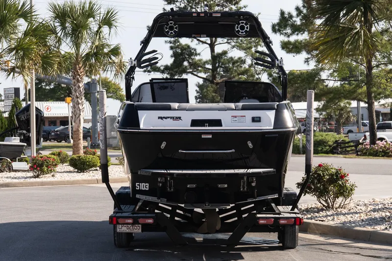 Slide: The Image of 2022 Moomba Max boat on trailer, parked outdoors with palm trees in background. - 5