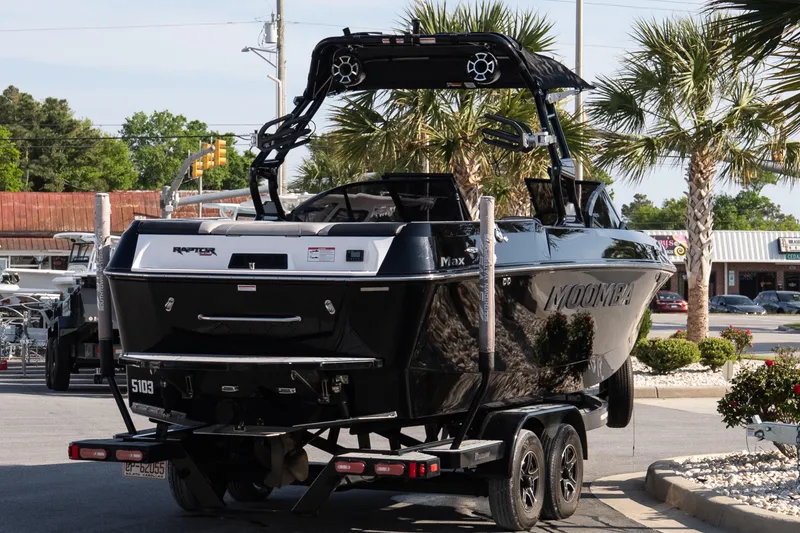 Slide: The Image of 2022 Moomba Max boat on trailer, parked outdoors near palm trees. - 6