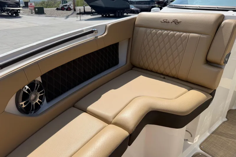 Slide: The Image of Luxurious tan seating on 2021 Sea Ray SLX 280 boat, featuring diamond stitching and speaker. - 15