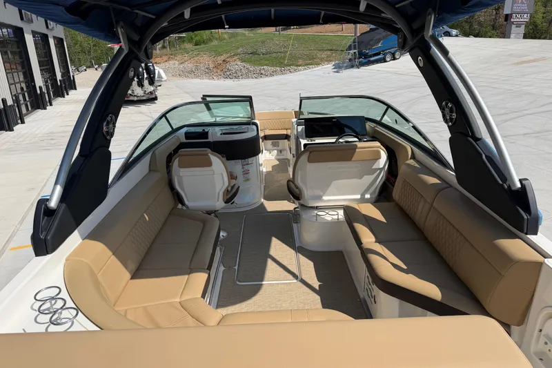 Slide: The Image of 2021 Sea Ray SLX 280 boat interior with tan seating and modern dashboard. - 18