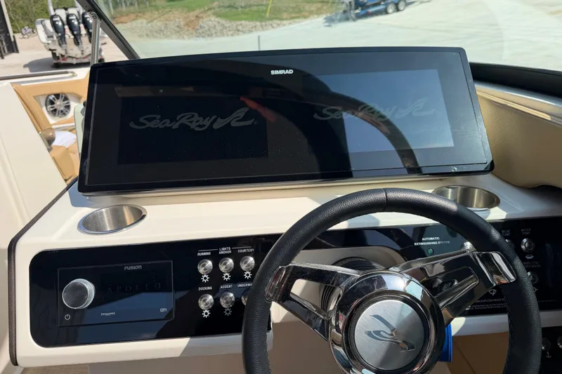Slide: The Image of 2021 Sea Ray SLX 280 dashboard with steering wheel and control panel. - 21