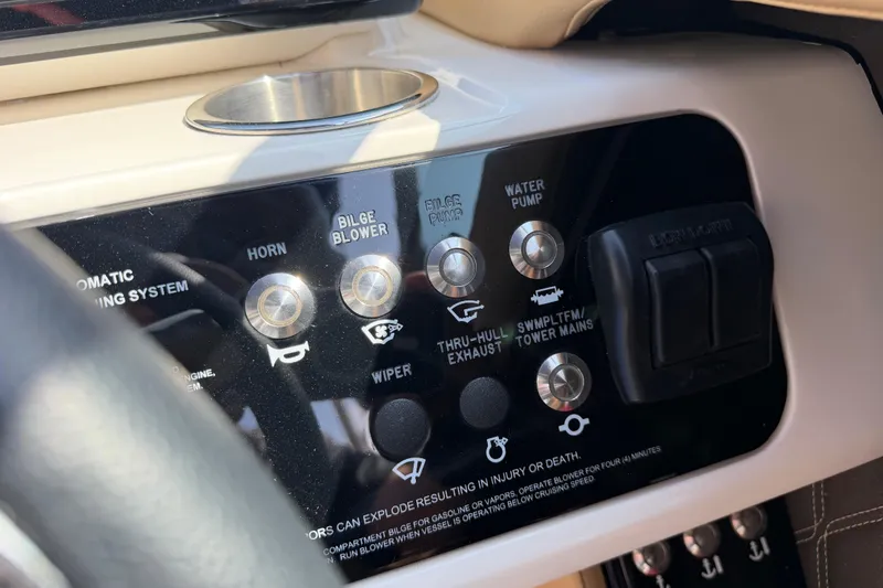 Slide: The Image of Control panel of a 2021 Sea Ray SLX 280 boat with various switches and buttons. - 28