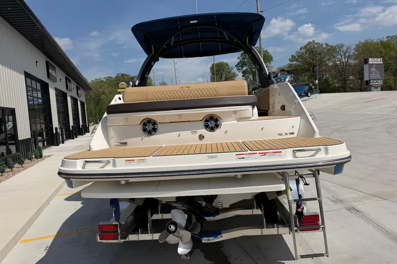 Slide: The Image of 2021 Sea Ray SLX 280 boat at a marina, showcasing rear deck and seating. - 4