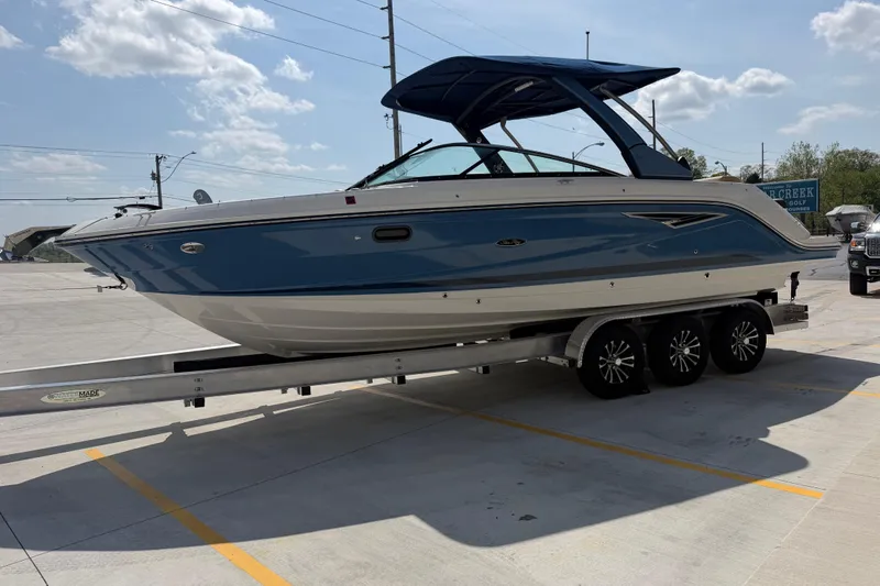 Slide: The Image of 2021 Sea Ray SLX 280 boat on trailer under clear sky. - 7