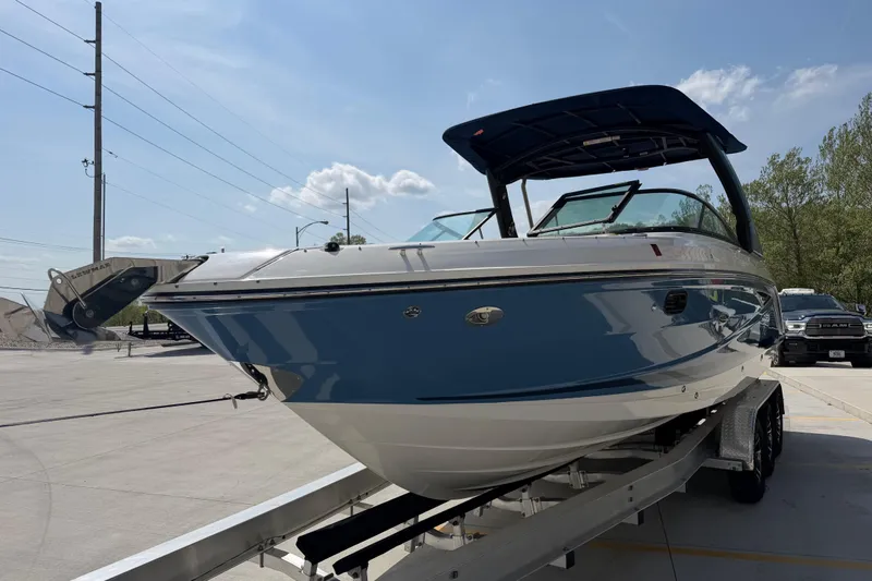Slide: The Image of 2021 Sea Ray SLX 280 boat on trailer under clear blue sky. - 9