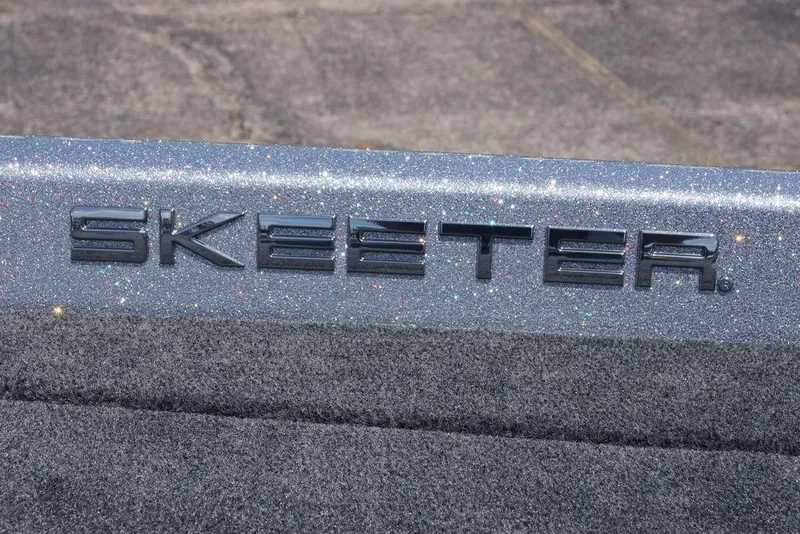 Slide: The Image of 2026 Skeeter ZXE21 boat logo on glittery surface, showcasing brand detail. - 10