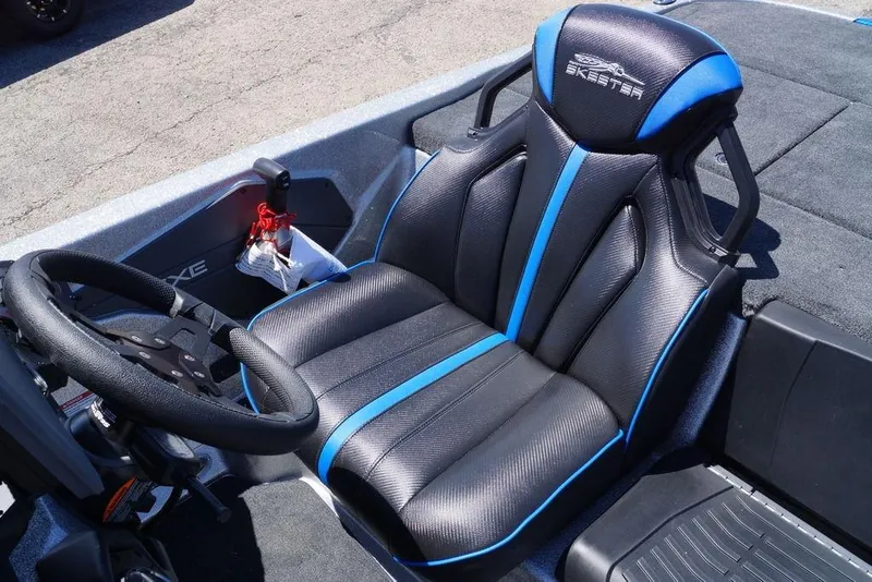 Slide: The Image of 2026 Skeeter ZXE21 boat interior with black and blue seat and steering wheel. - 14