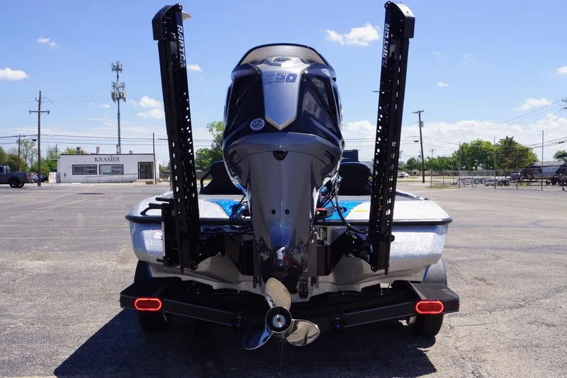 Slide: The Image of 2026 Skeeter ZXE21 boat rear view with powerful outboard motor in parking lot. - 4