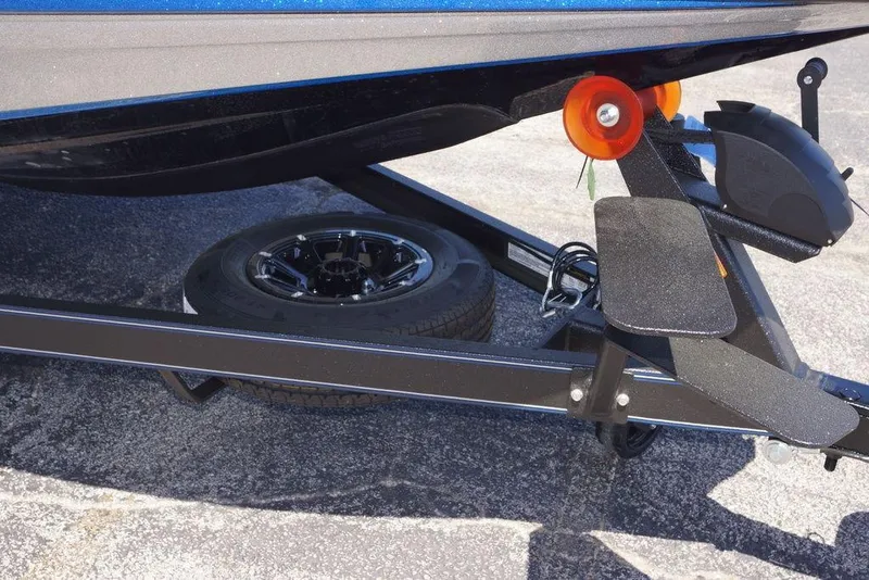 Slide: The Image of 2026 Skeeter ZXE21 boat trailer with black wheel and orange roller. - 6