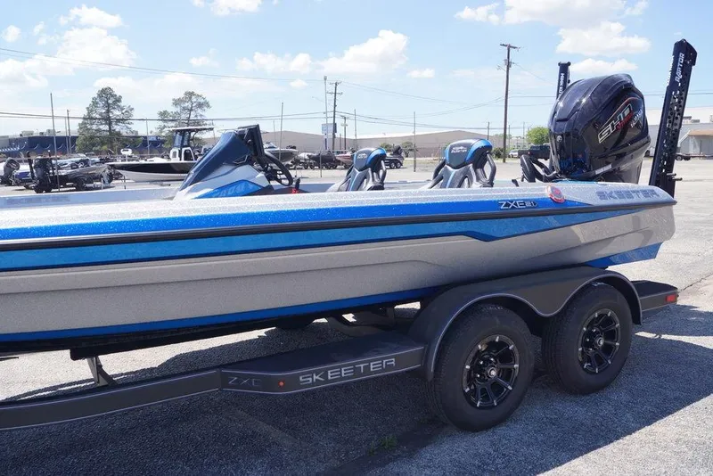 Slide: The Image of 2026 Skeeter ZXE21 boat with sleek design on a trailer, parked outdoors. - 8