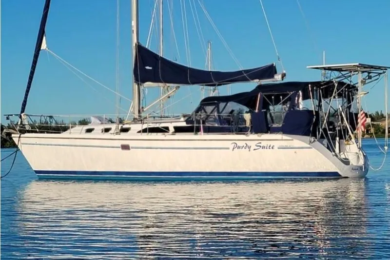 The Image of Sailboat Catalina 42 MkII 1998 on calm water, featuring blue and white design. - 0